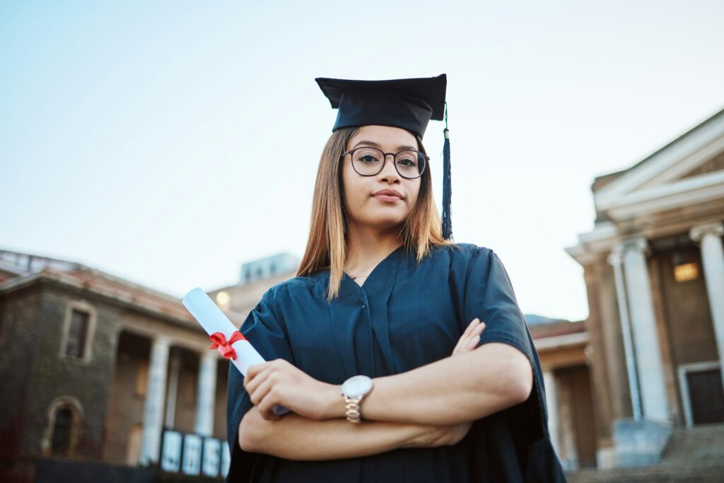 Graduation, education and portrait of woman at university, college and academic campus with diploma